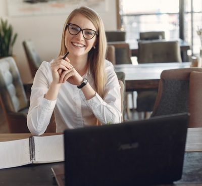 cheerful-young-businesswoman-in-eyeglasses-during-remote-3874619
