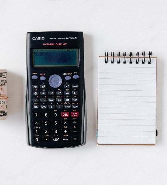 composition-of-calculator-with-paper-money-and-notebook-with-4386341